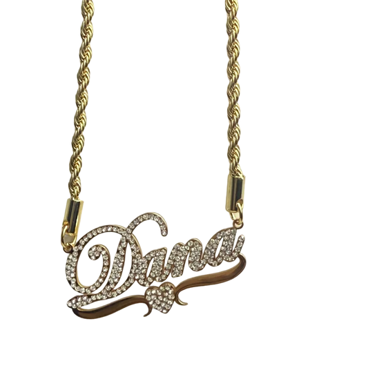 Gold necklace with a decorative clasp on a light gray background