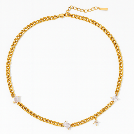Gold chain necklace with small diamonds on a white background