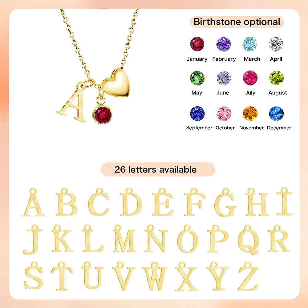 Gold initial necklace with a letter A, a heart charm, and a red birthstone charm, shown alongside a color selection chart for birthstones and a set of gold alphabet letter charms labeled '26 letters available'.