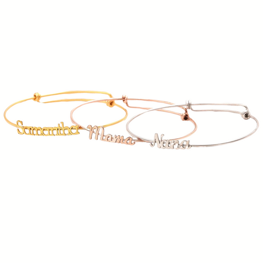 A collection of three adjustable bracelets in gold, rose gold, and silver colors, each with a different name written on them.