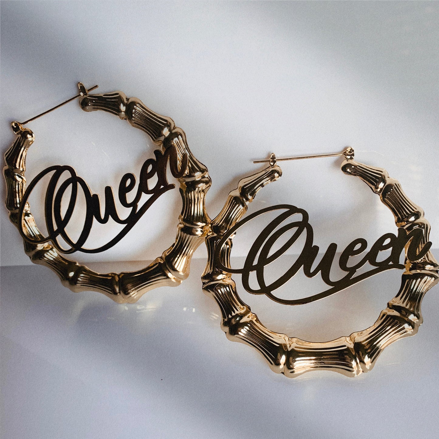 Custom name bamboo hoop earrings in gold with personalized lettering, Queendom Treasurez.