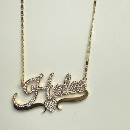 Gold necklace with a decorative pendant on a light gray background