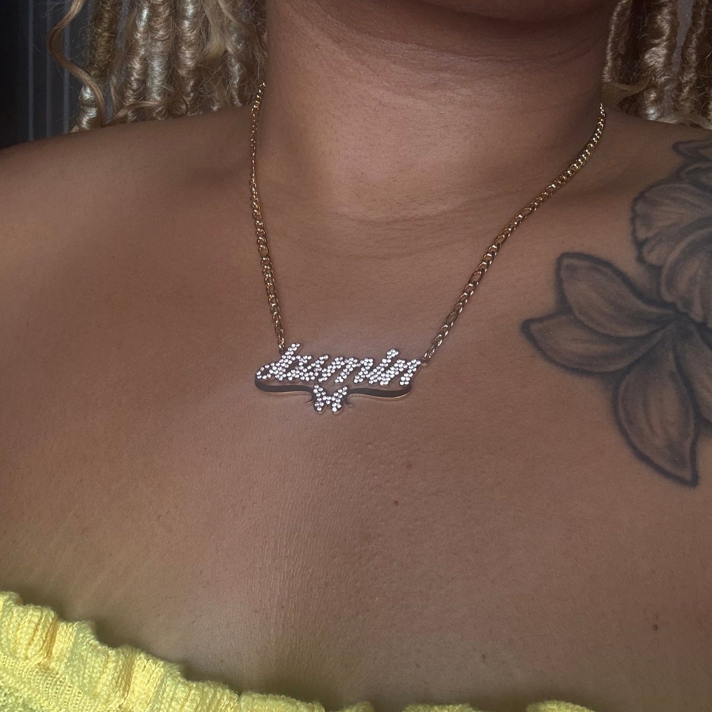 Necklace with a diamond pendant on a person's neck, close-up view.