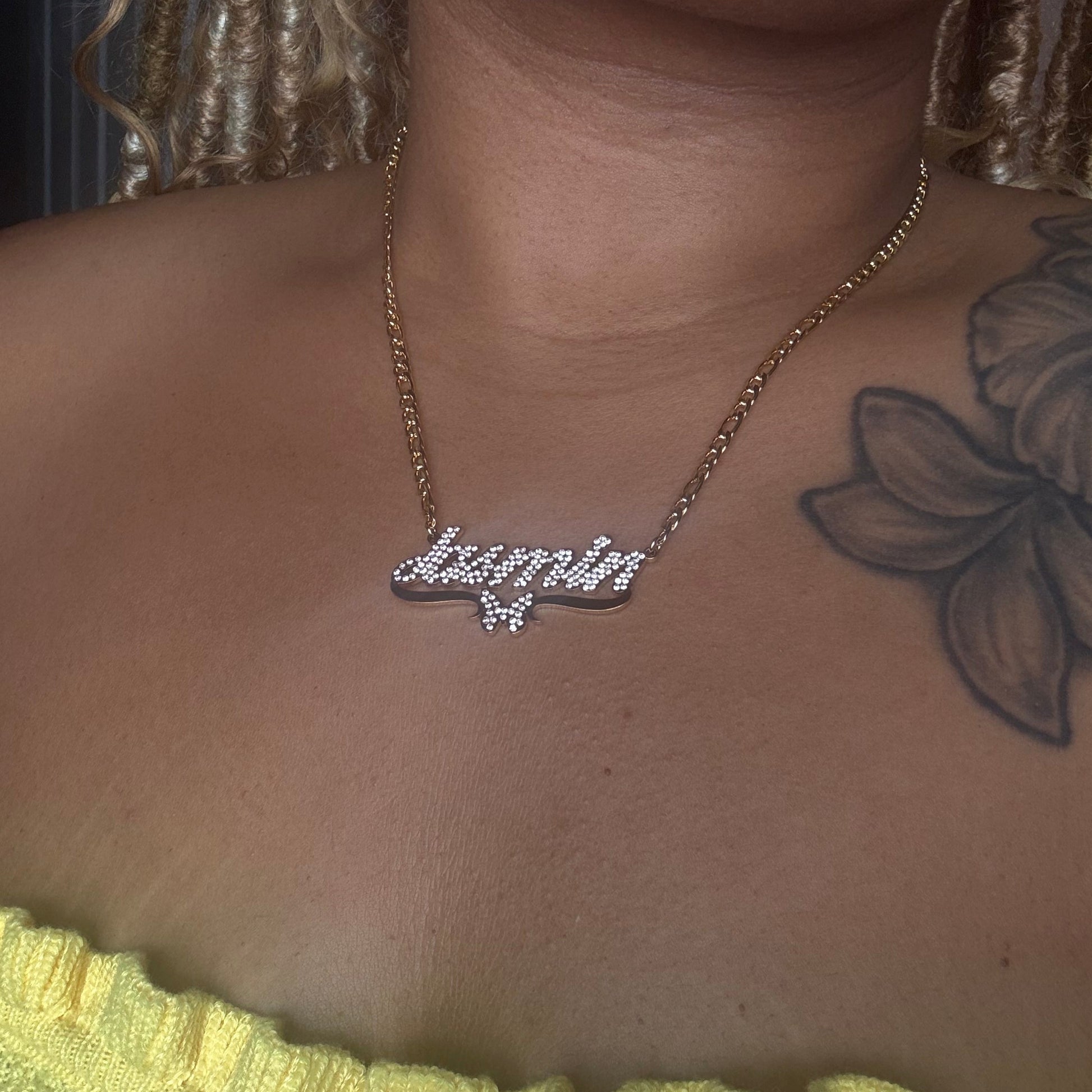 Necklace with a diamond pendant on a person's neck, close-up view.