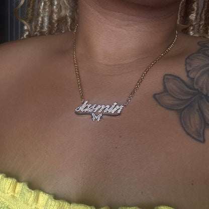 Necklace with a diamond pendant on a person's neck, close-up view.