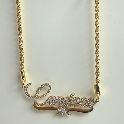 Gold necklace with intricate design on a light gray background