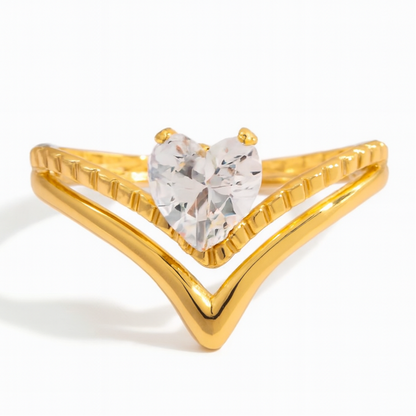 Gold ring with a heart-shaped gemstone on a white background