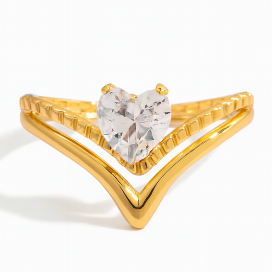Gold ring with a heart-shaped gemstone on a white background