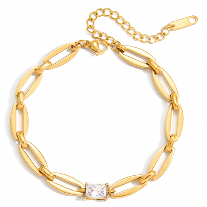 Gold chain bracelet with a central diamond on a white background