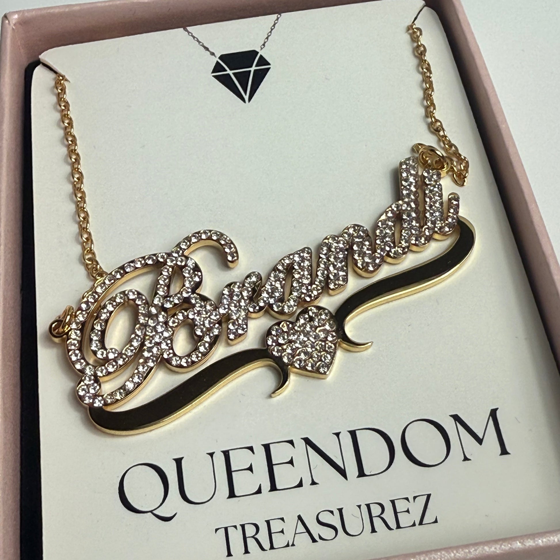 Decorative headband with crystals on a 'Queendom Treasurez' branded card.