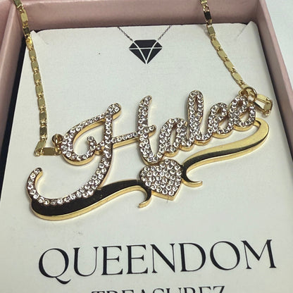Decorative brooch with 'QUEENDOM TREASUREZ' branding on a box.