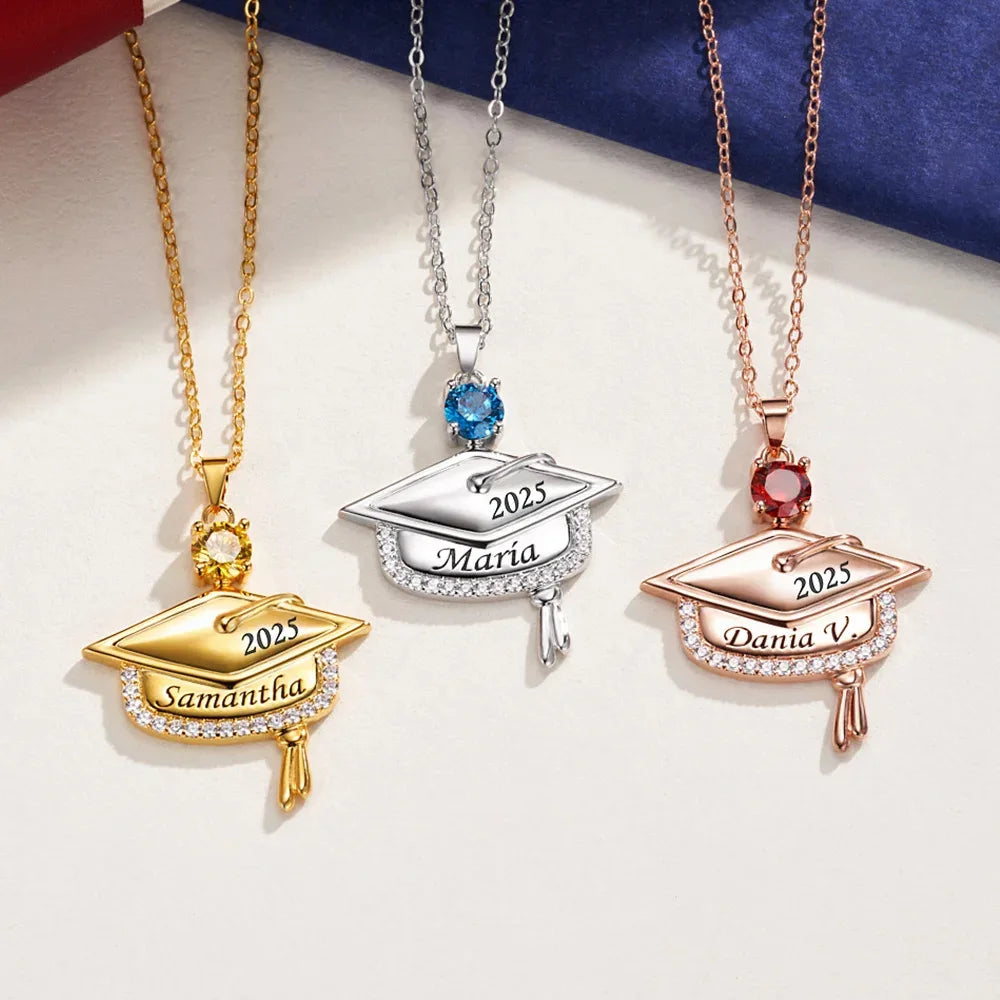 Three graduation cap necklaces in gold, silver, and rose gold with names and years engraved.