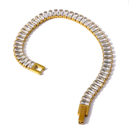 Gold bracelet with clear gemstones on a white background