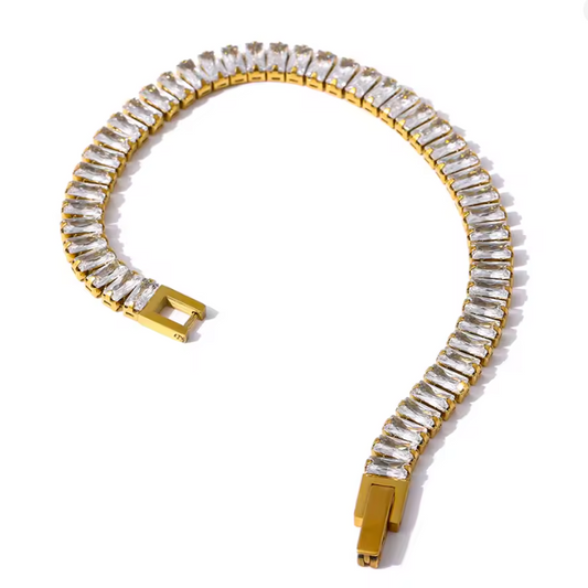 Gold bracelet with clear gemstones on a white background