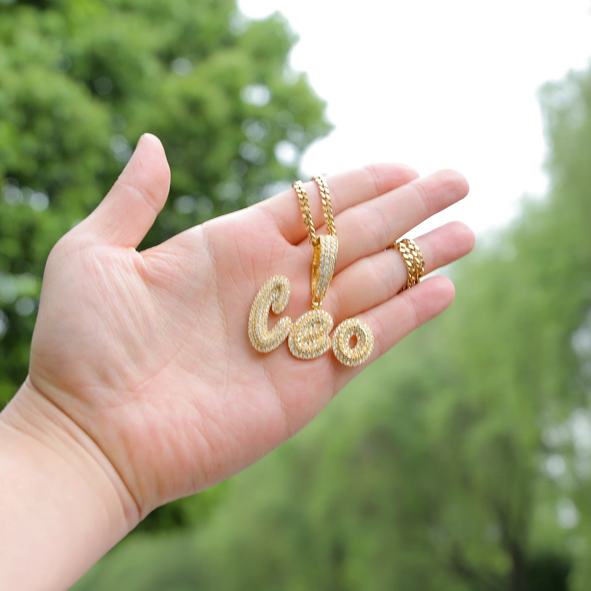 Iced-out custom bubble cursive name necklace with personalized engraving and sparkling stones – Queendom Treasurez.