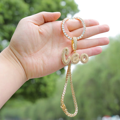 Iced-out custom bubble cursive name necklace with personalized engraving and sparkling stones – Queendom Treasurez.