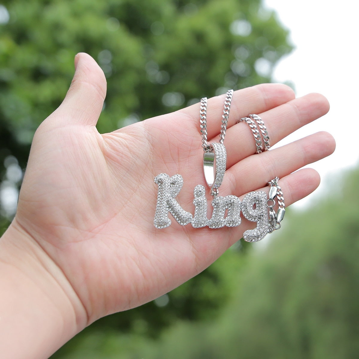 Iced-out custom bubble cursive name necklace with personalized engraving and sparkling stones – Queendom Treasurez.